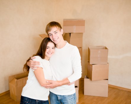 Professional movers transporting household furniture through a Chiswick street