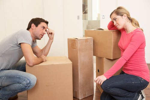 Estimator reviewing cubic-yard volume for a Chiswick flat move