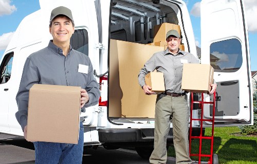 Careful loading of sofas and tables for a local furniture removal job