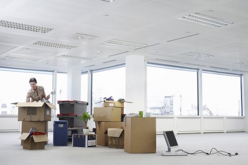 Packed office furniture and labelled boxes ready for transport in a Chiswick business move
